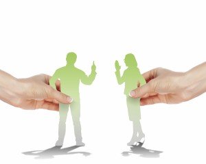 2 paper figures held by human hands appear to argue